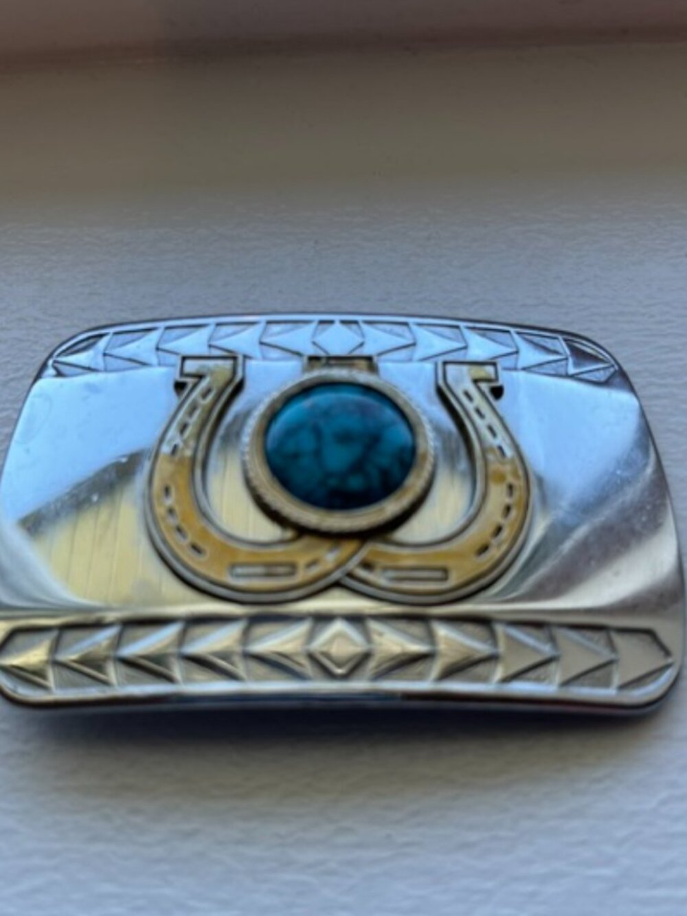 Western style belt buckle horseshoe design.